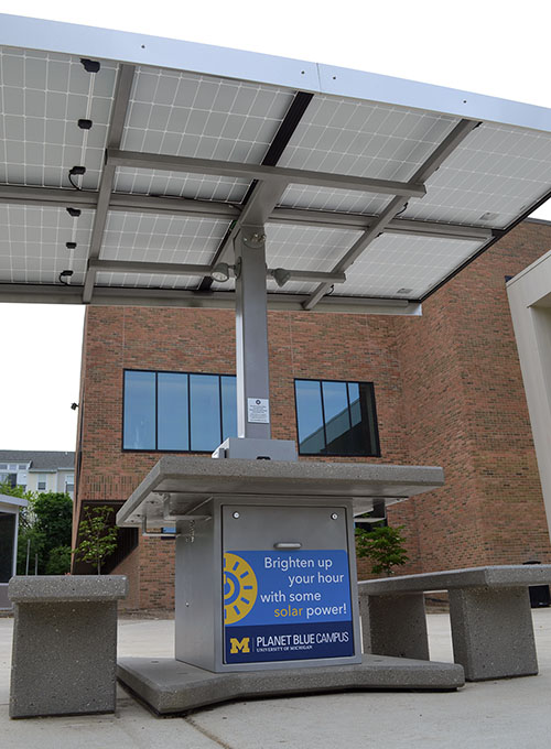 A picnic table with a roof made of solar panels